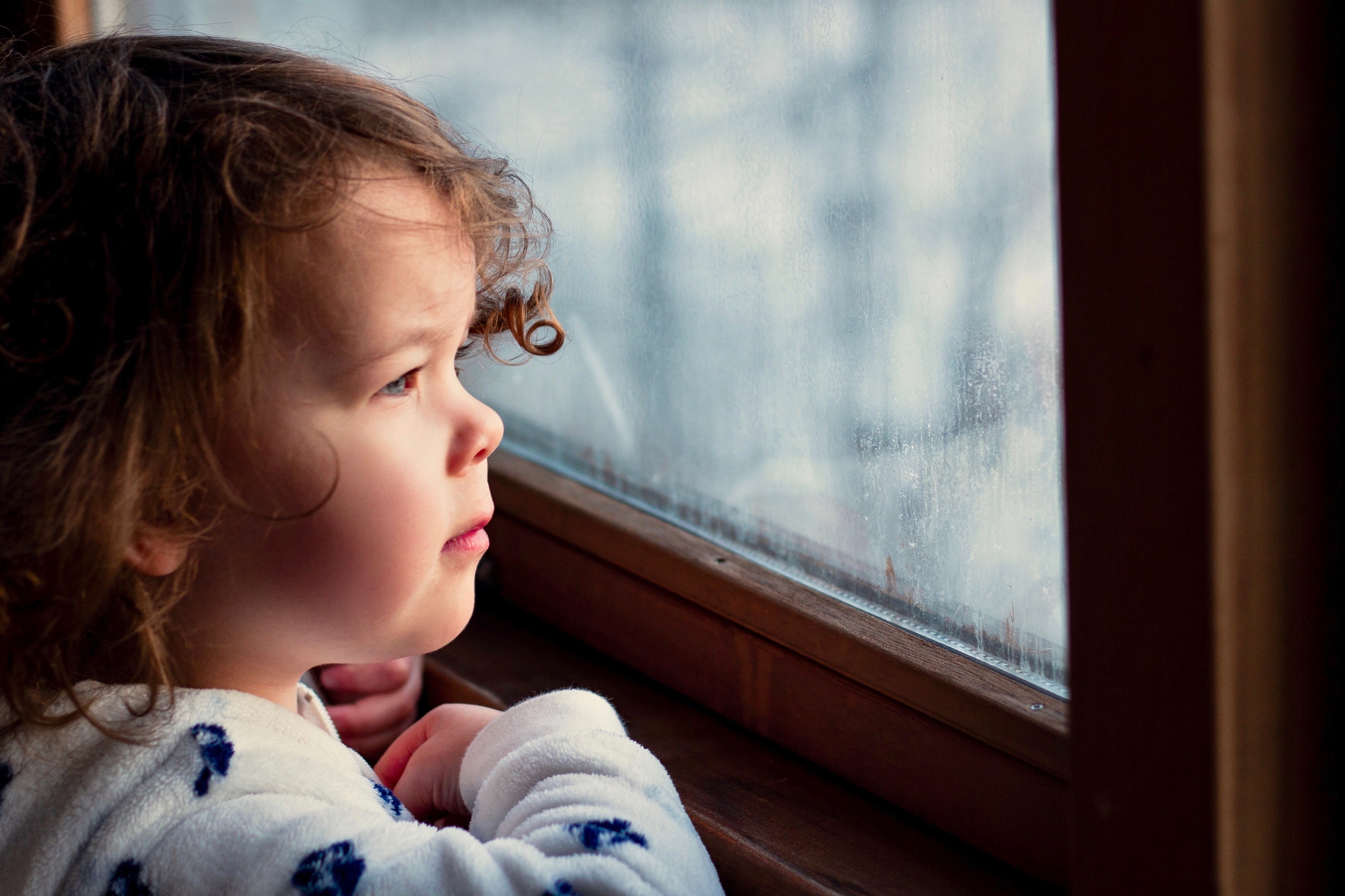 child looking out window