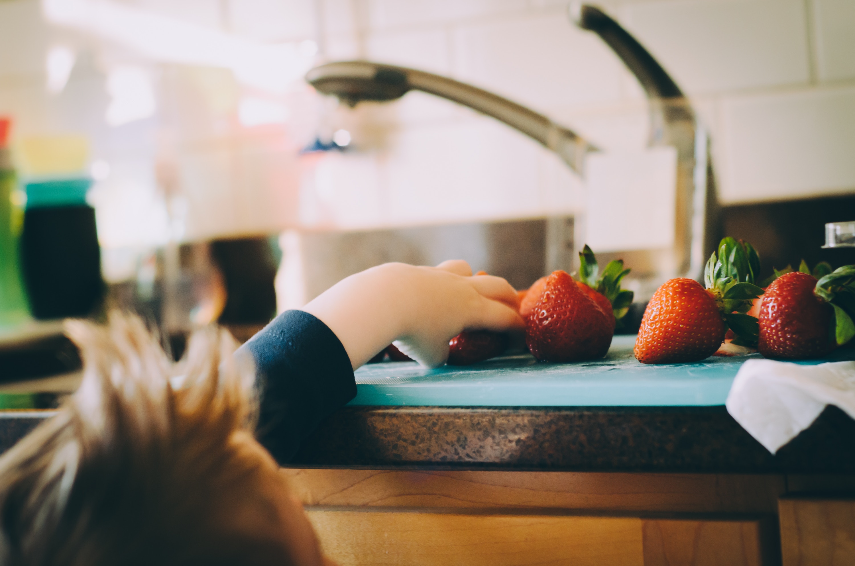 child hand reaching for berries